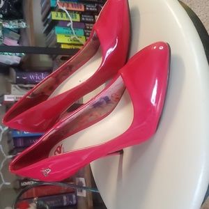 Red patent pumps